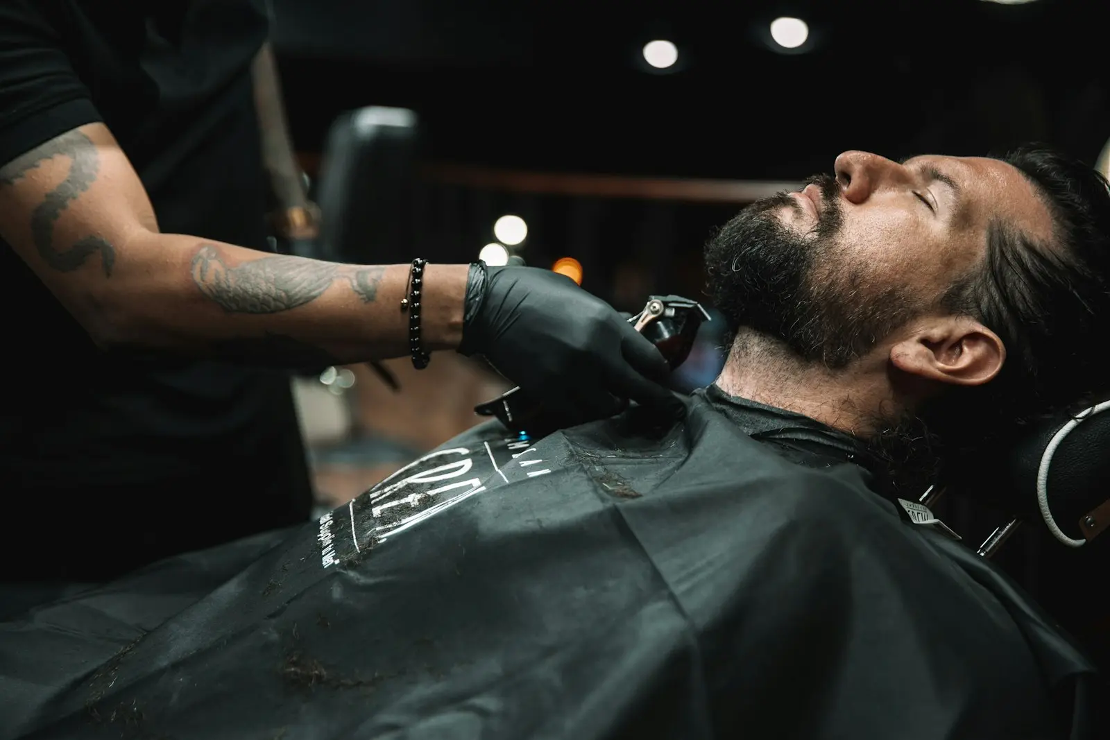 Barbero arreglando la barba de un cliente